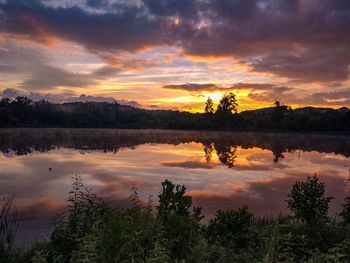 Scenic view of lake against orange sky