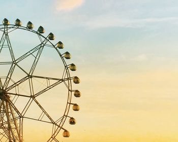 Low angle view of ferris wheel against sky