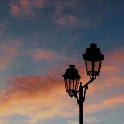 Low angle view of silhouette lamp against sky during sunset