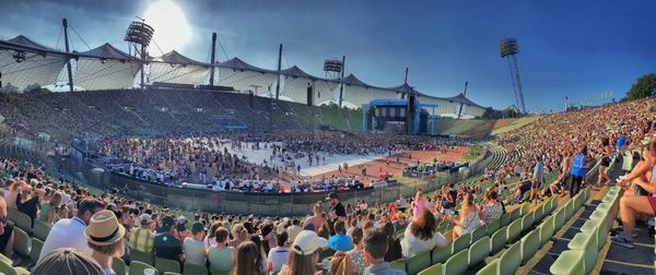 Panoramic of people in stadium against sky