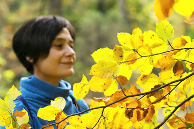 Portrait of boy with yellow leaves
