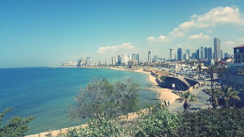 Panoramic view of sea and buildings against sky