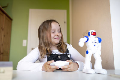 Portrait of smiling girl holding toy