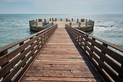 Pier over sea against sky