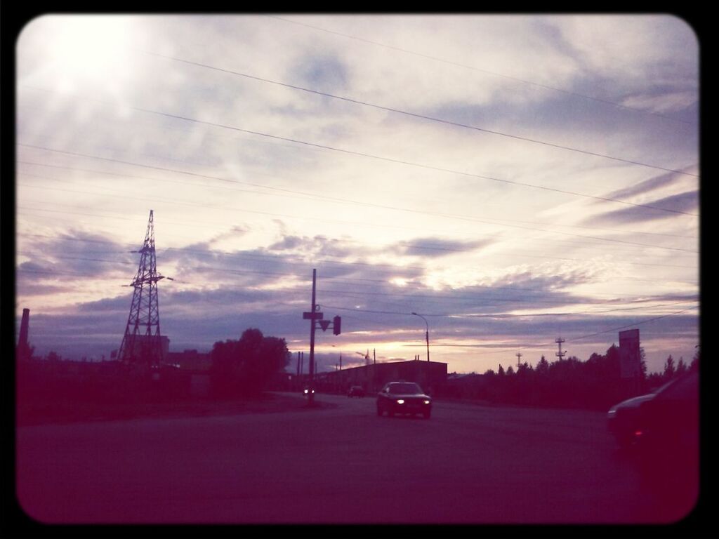 transportation, transfer print, sky, road, sunset, car, cloud - sky, electricity pylon, auto post production filter, silhouette, land vehicle, power line, cloudy, cloud, street, tree, mode of transport, fuel and power generation, outdoors, connection