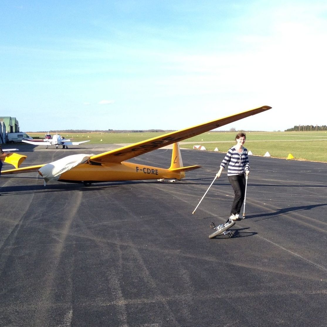 lifestyles, transportation, leisure activity, full length, sky, airplane, mid-air, casual clothing, mode of transport, air vehicle, travel, sunlight, outdoors, on the move, day, flying, cloud - sky, young adult