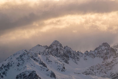 Scenic view of snowcapped mountains against sky during sunset