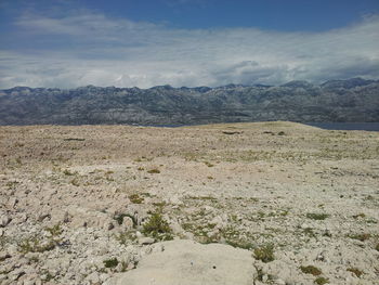 Scenic view of mountains against cloudy sky