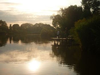 Scenic view of lake at sunset