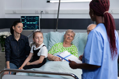 High angle view of people sitting on bed