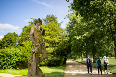 Statue in park against sky