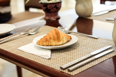 Close-up of croissant on table