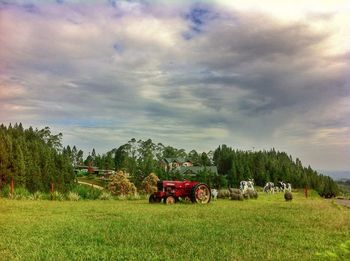 Scenic view of field against cloudy sky