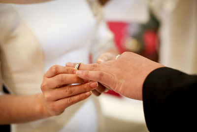 Midsection of couple holding hands