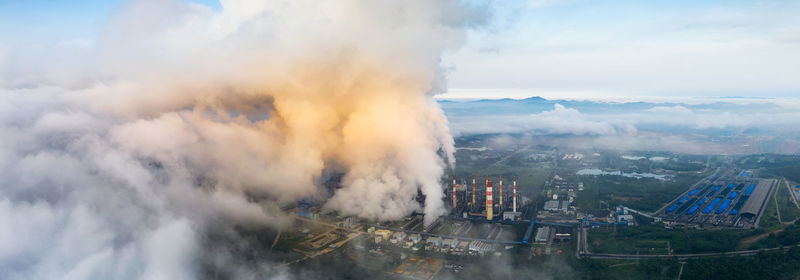 High angle view of smoke emitting from chimney against sky. coal power plant.