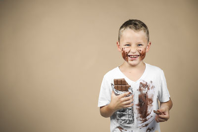 Portrait of smiling boy holding camera