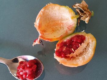 Close-up of hand holding strawberries on table