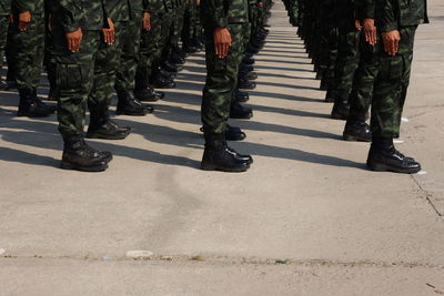 Rear view of soldiers standing on street