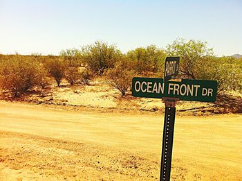 Information sign on landscape against clear sky