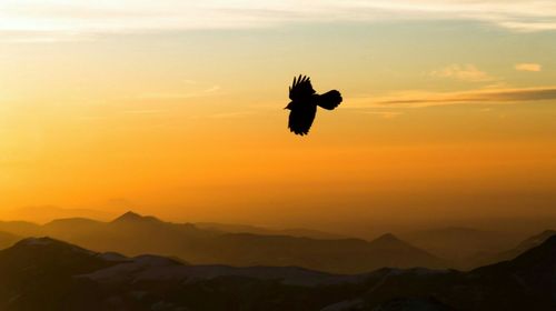 Scenic view of mountains against sky at sunset