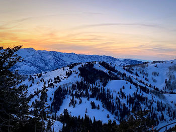 Scenic view of snowcapped mountains against sky during sunset