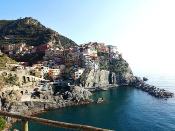 Townscape by sea against clear sky