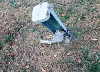 High angle view of broken toy car on field