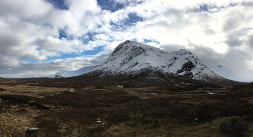 Scenic view of mountains against cloudy sky