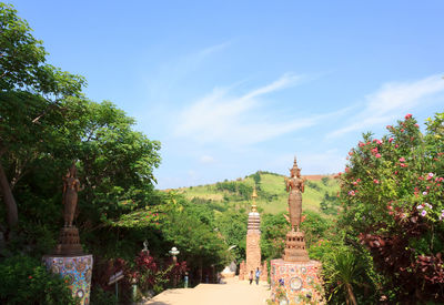 Trees in temple against sky