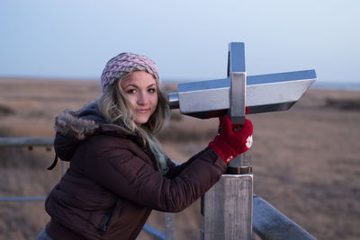 Portrait of woman with binoculars outdoors 