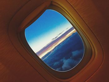 Close-up of blue sky seen through airplane window