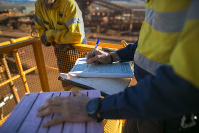 Midsection of colleagues at construction site