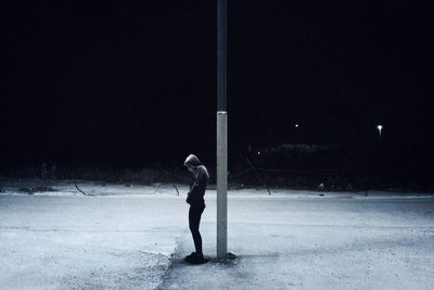 Full length of woman walking on road at night