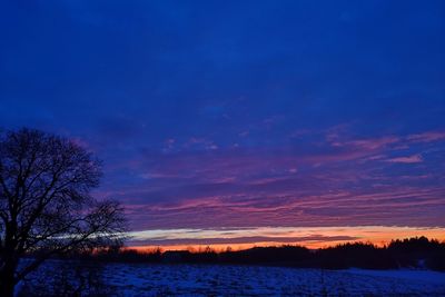 Scenic view of lake against romantic sky at sunset
