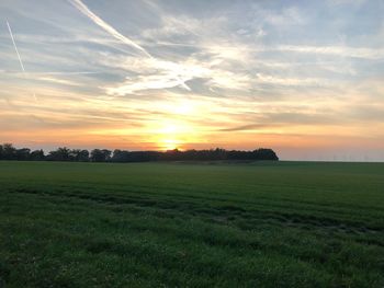 Scenic view of field against sky during sunset