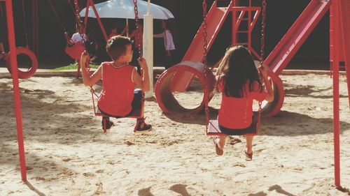 People on swing at playground