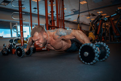 Muscular man exercising in gym