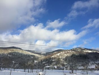 Scenic view of snowcapped mountains against sky