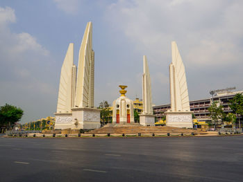 Low angle view of monument and building against sky
