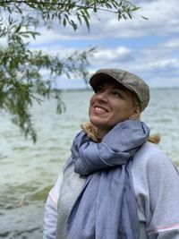 Portrait of smiling woman standing in sea