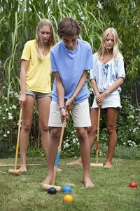 Teenager playing croquet