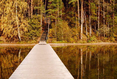 Wooden pier and wooden stairs to hill on lake baltieji lakajai in labanoras regional park, lithuania