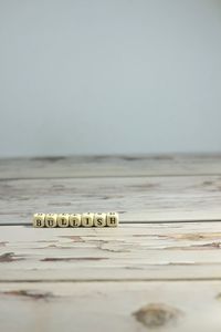 Close-up of coins on table against clear sky