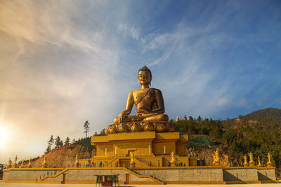 Low angle view of statue against sky