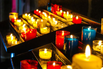 Close-up of illuminated candles in temple