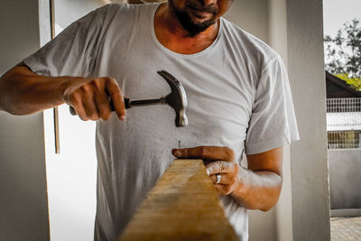 Close-up of man holding camera at home