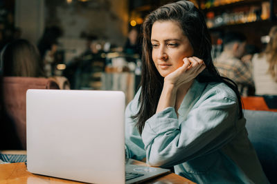 Young woman using laptop at home