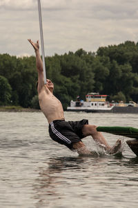 Man surfing in swimming pool against sky