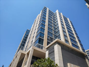 The mordan building in dubai city is extraordinarily beautiful against the blue sky