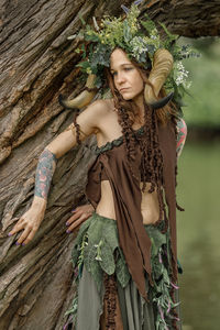 Portrait of young woman standing in forest